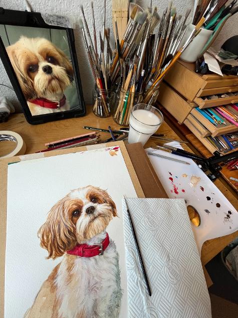 shih tzu painting in progress on artists table